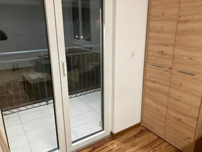 a sliding glass door in a room with a balcony at Apartman Raj in Vrnjci