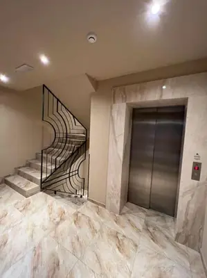 a lobby with a staircase and a metal door at Ema - Jakov Kopaonik Kraljevi Čardaci in Kopaonik