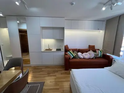 a living room with a couch and a kitchen at Ema - Jakov Kopaonik Kraljevi Čardaci in Kopaonik