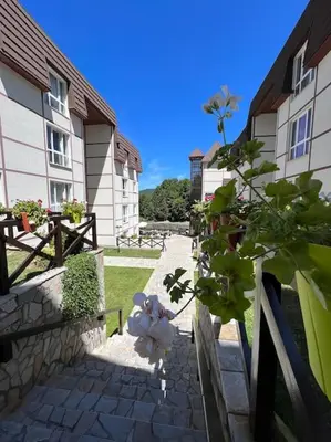 a teddy bear sitting on a fence next to a building at Ema - Jakov Kopaonik Kraljevi Čardaci in Kopaonik