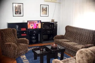 a living room with two couches and a tv at Apartman LUX*** in Leskovac