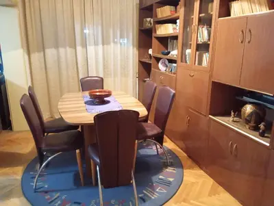 a dining room table with chairs and a bowl on top of it at Apartman LUX*** in Leskovac