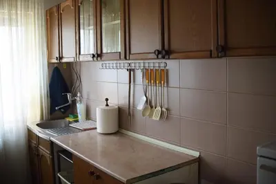 a kitchen with a counter with utensils on the wall at Apartman LUX*** in Leskovac