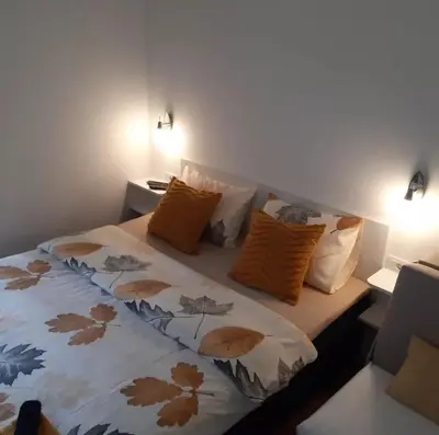 a bedroom with a bed with orange pillows at Vila Jevtić studio 3 in Soko Banja