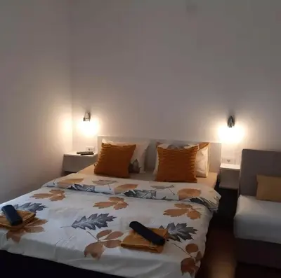 a bedroom with a large bed with towels on it at Vila Jevtić studio 3 in Soko Banja