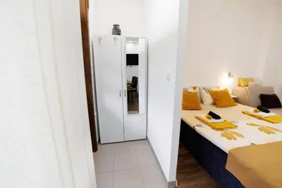 a small room with a bed and a mirror at Vila Jevtić studio 3 in Soko Banja