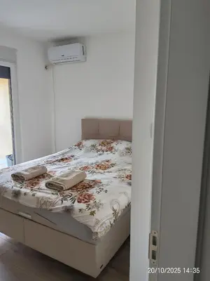 a bed with two books on it in a room at Lacky-ca in Prokuplje
