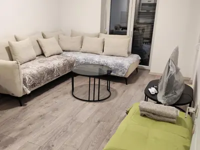 a living room with a couch and a glass table at Lacky-ca in Prokuplje