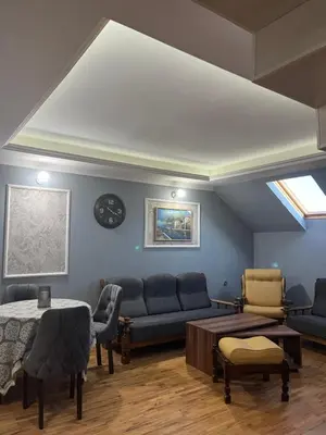 a living room with a couch and a table at Royal suite Nis in Niš
