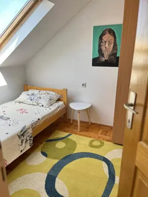 a bedroom with a bed and a yellow rug at Royal suite Nis in Niš