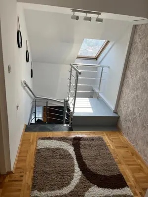 a stairwell with a rug and a window in a room at Royal suite Nis in Niš
