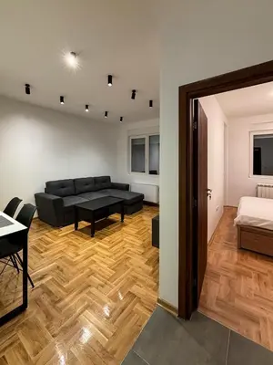 a living room with a couch and a bed at Apartman Grey LUX in Pirot