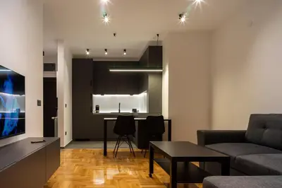 a living room with a couch and a table at Apartman Grey LUX in Pirot