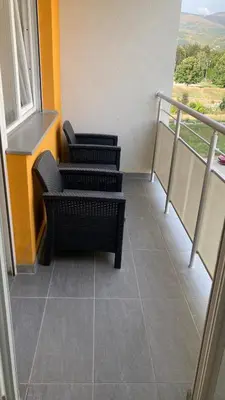 a room with three chairs and a balcony at Apartman Grey LUX in Pirot