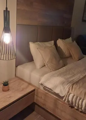 a bedroom with a bed and a lamp on a table at Apartman Viva Milmari in Kopaonik
