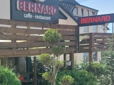 a sign for a restaurant in front of a building at Apartman Viva Milmari in Kopaonik