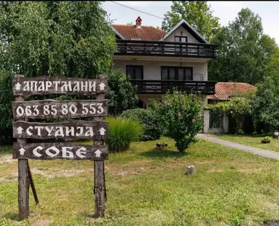 a sign in front of a house with a house at Vila Jevtić studio 1 in Soko Banja