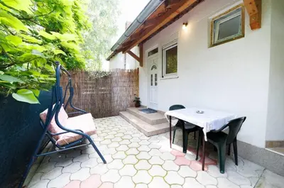 a patio with a table and chairs in front of a house at Vila Jevtić studio 1 in Soko Banja