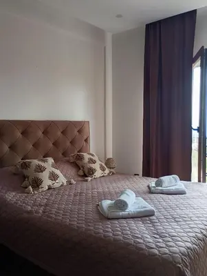 a bedroom with a bed with two towels on it at Milmari resort N12 in Kopaonik