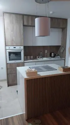 a kitchen with a counter with a sink and a stove at Apartman Kraljice Natalije in Vrnjačka Banja