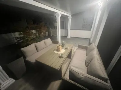 a living room with a couch and a table at Apartman Kraljice Natalije in Vrnjačka Banja