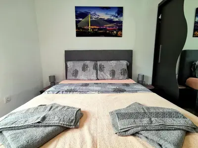 a bedroom with a bed with two blankets on it at Trajkovic One Bedroom Apartment in Soko Banja