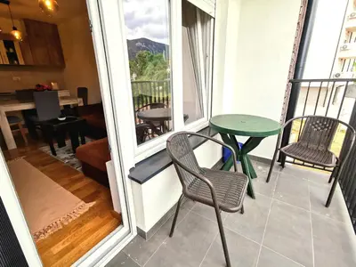 a balcony with a table and chairs and a table at Trajkovic One Bedroom Apartment in Soko Banja