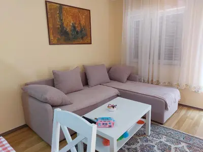 a living room with a couch and a table at Dukat in Soko Banja