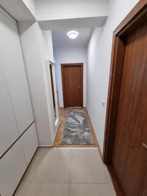 an empty hallway with a door and a rug at Marlux 2 in Pirot
