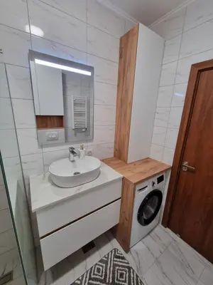 a bathroom with a sink and a washing machine at Marlux 2 in Pirot