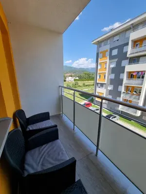 a balcony with a chair and a view of a building at Marlux 2 in Pirot