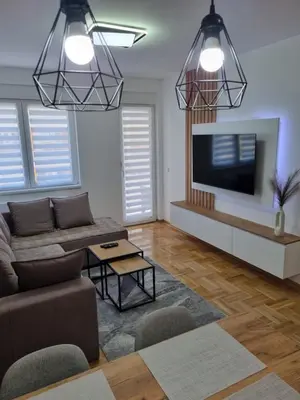 a living room with a couch and a flat screen tv at Marlux 2 in Pirot