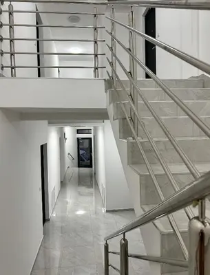 a staircase in a building with white walls at Millie's apartments in Ćuprija