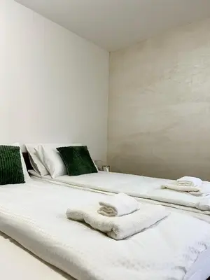 a bedroom with two beds with towels on them at Millie's apartments in Ćuprija