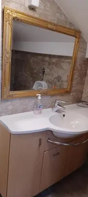 a bathroom with a sink and a mirror at Vikendica Sofia in Žagubica