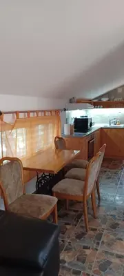 a dining room with a table and chairs at Vikendica Sofia in Žagubica