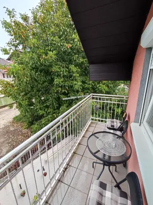 a patio with a table and chairs on a balcony at Latinski apartman in Soko Banja