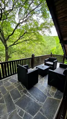 a patio with chairs and tables and a fence at Vila Dolina Mira in Zabrega