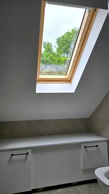 a skylight in a bathroom with a toilet and a window at Vila Dolina Mira in Zabrega