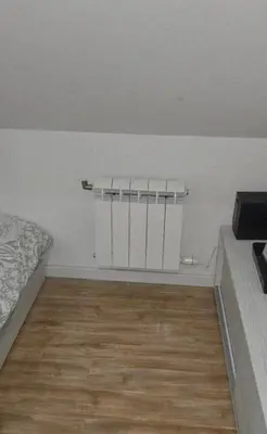 a room with a bed and a wooden floor at Vila Dolina Mira in Zabrega