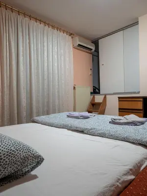 two beds sitting next to each other in a room at Apartman Aleksandar in Kruševac