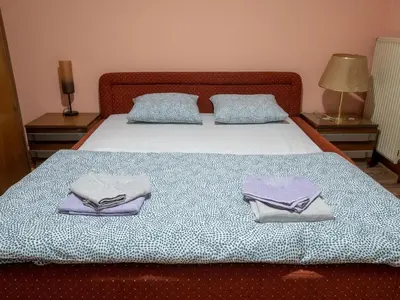 a bed with two folded towels on top of it at Apartman Aleksandar in Kruševac