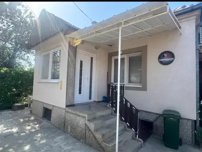 a house with awning and stairs in front of it at Apartman Meridian in Zaječar