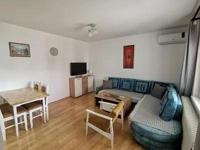 a living room with a couch and a table at Apartman Meridian in Zaječar