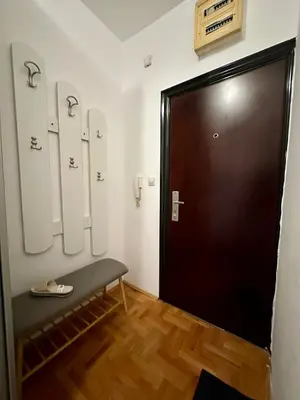 a door in a room with a bench in front of it at PLANIS apartments in Niš