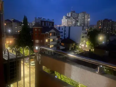 a view of a city at night with buildings at PLANIS apartments in Niš