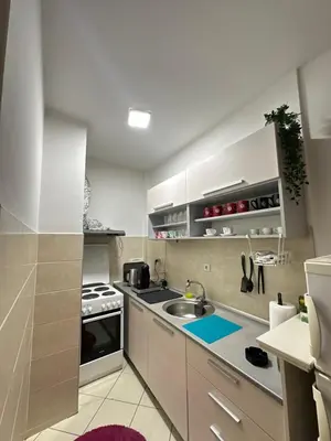 a kitchen with a sink and a stove at PLANIS apartments in Niš
