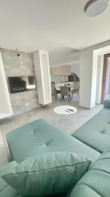 a living room with a couch and a table at Amigos Suits in Niš