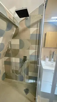 a bathroom with a shower and a sink at Amigos Suits in Niš