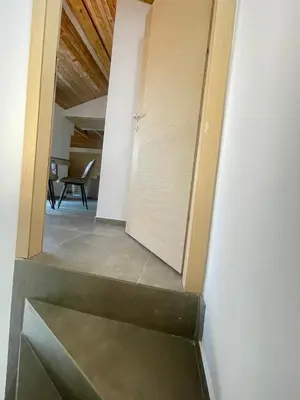 a stairway leading to a room with a door at Amigos Suits in Niš